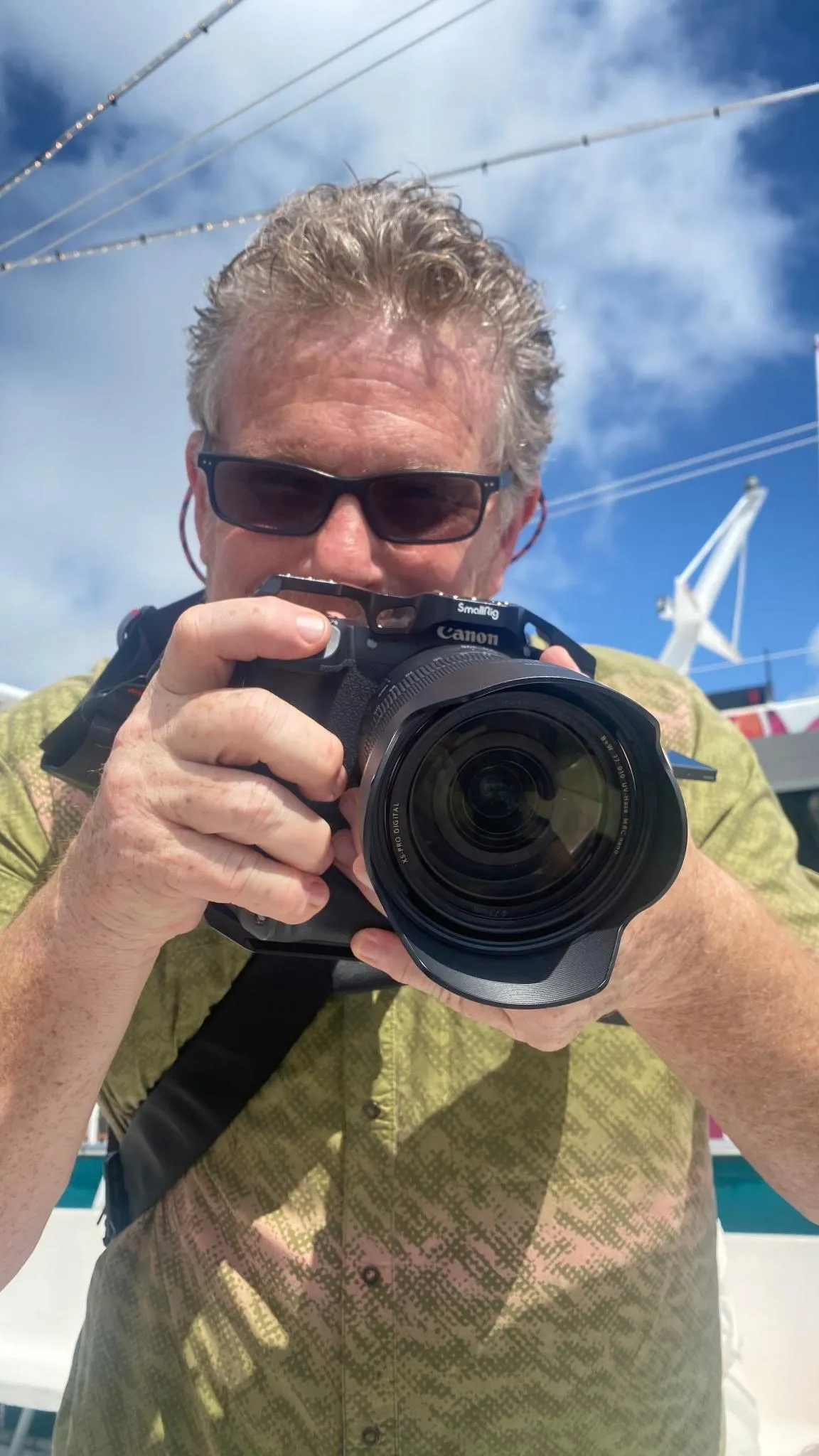 Joe Mitchell of Space Coast Camera holding a professional Canon camera with a SmallRig cage, offering expert photography gear advice and rentals in Indialantic, Florida.