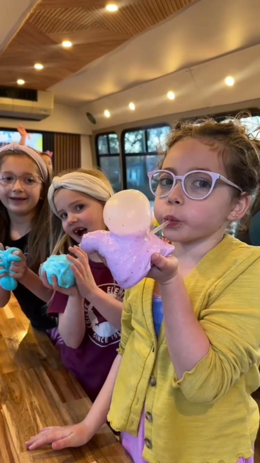 Kids enjoying slime and cotton candy together
