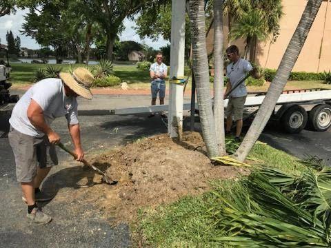 All Lighting Maintenance team performing ground preparation and excavation for a new light pole installation in Florida.