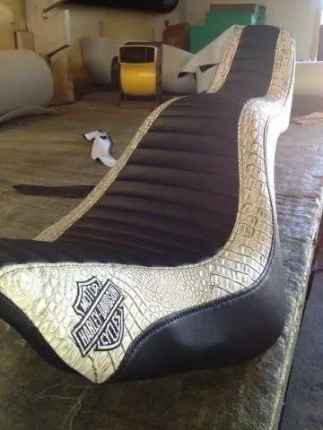 Custom Harley-Davidson motorcycle seat with black pleated leather and cream alligator skin accents, handcrafted by AE Auto Upholstery in Melbourne, FL.