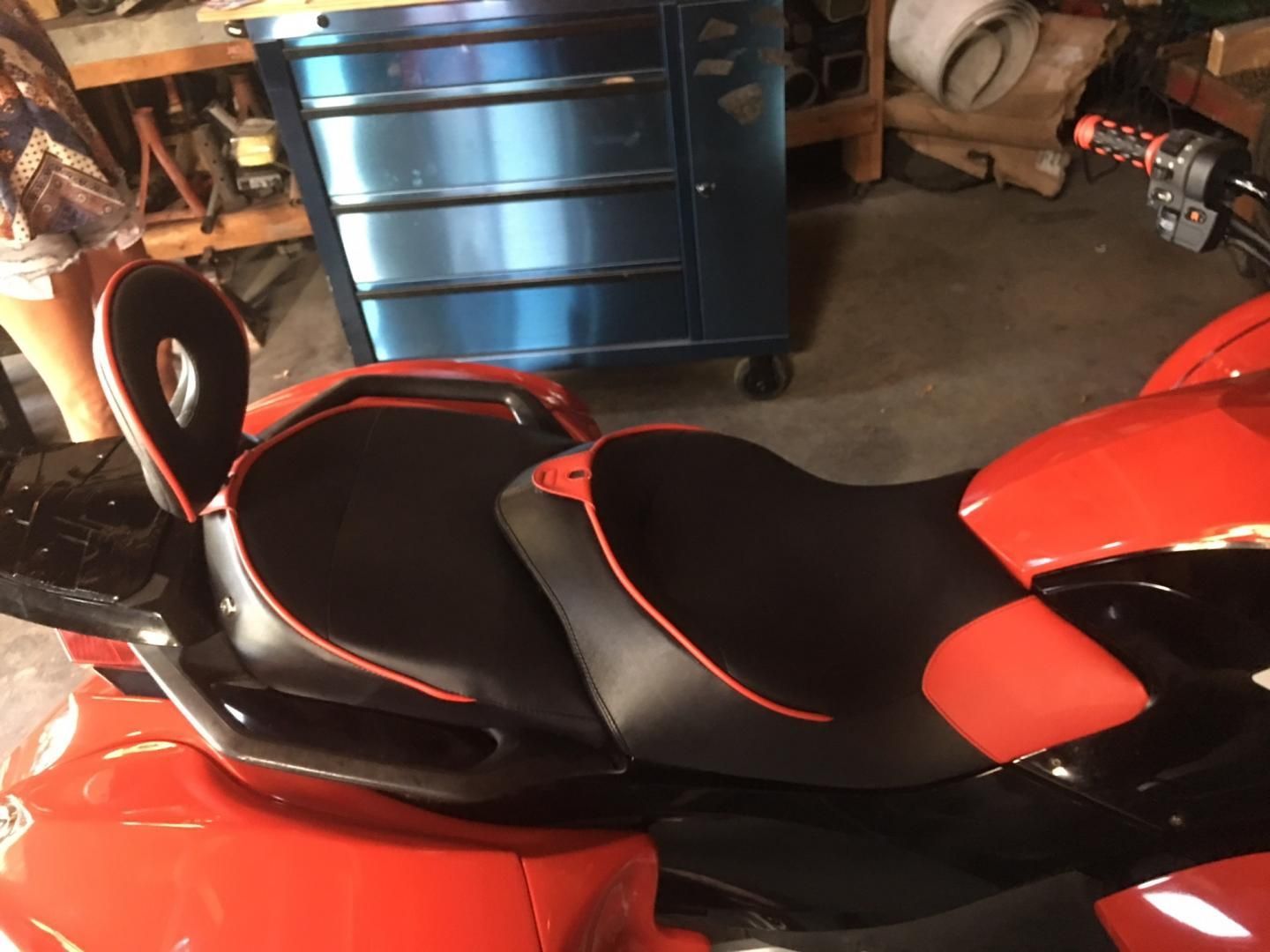 Custom red and black motorcycle trike seat with matching passenger backrest and red piping, professional upholstery by AE Auto Upholstery in Melbourne, Florida.