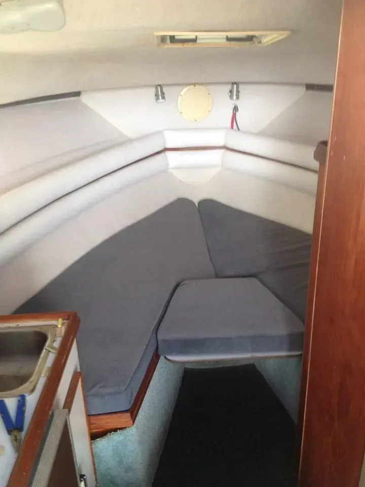 Custom grey v-berth cabin cushions and white wall padding for a boat interior restoration by AE Auto Upholstery in Melbourne, Florida.