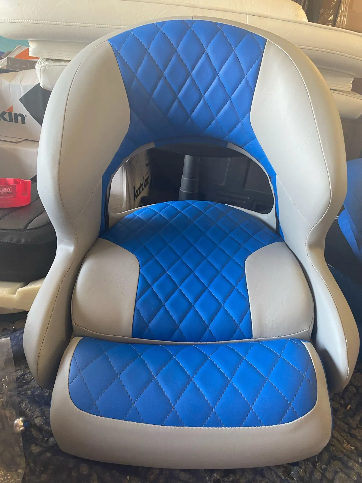 Four custom white marine bucket seats with black racing stripes and red piping for a high-performance boat in Melbourne, FL.