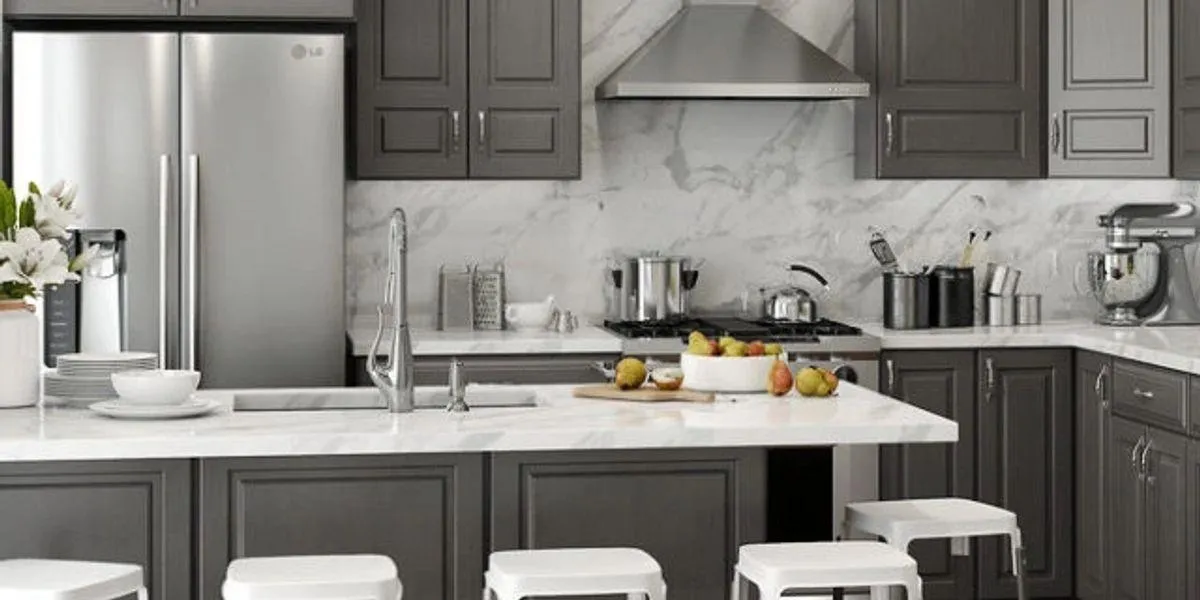Custom charcoal grey shaker cabinets with marble countertops and backsplash.
