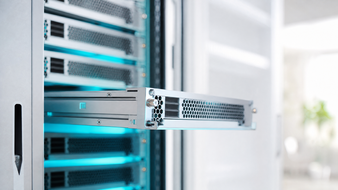 A server blade being installed with cyan lighting in a modern data center.