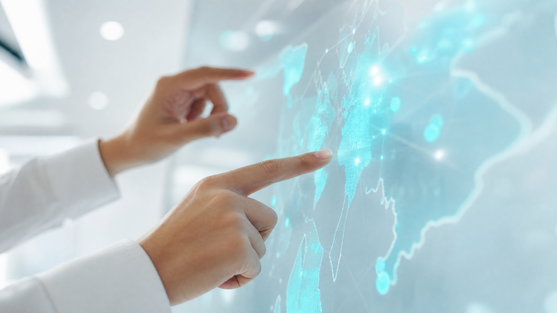 A digital dashboard with evolving cyan threat maps and hands interacting.