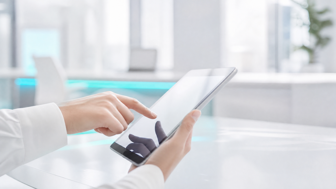 A close-up of hands reviewing digital contracts on a tablet, with a modern office in the background.